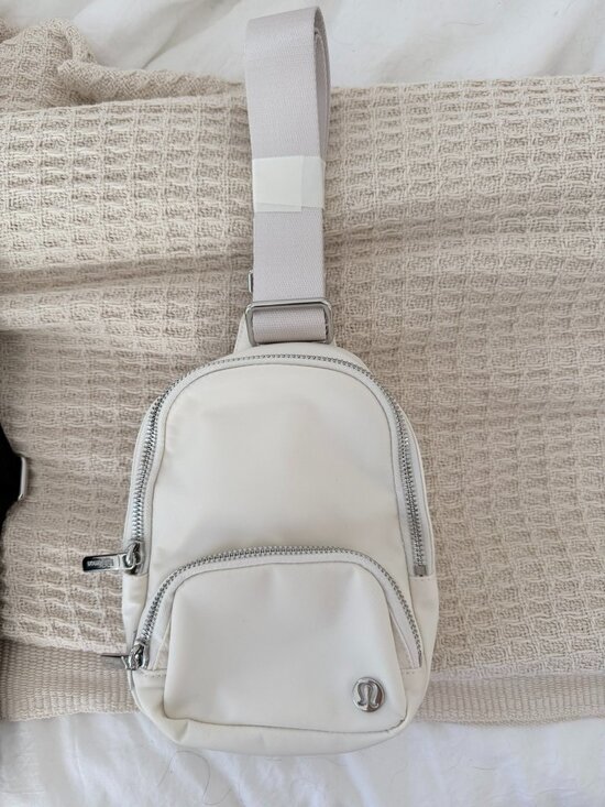 lululemon athletica Handbags - Lululemon Cream Mini Sling Backpack Silver Hardware